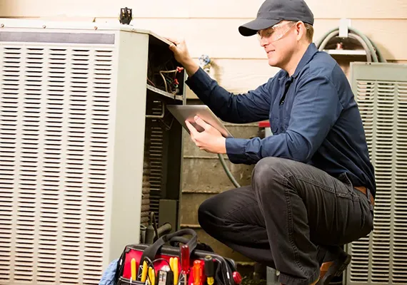 HVAC technician inspecting an indoor HVAC unit, highlighting the benefits of professional HVAC repair services.