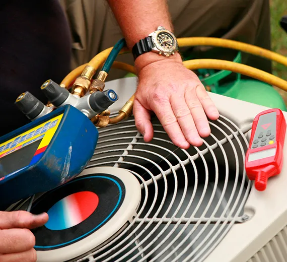 Close-up of hands repairing an HVAC system, emphasizing cost-effective solutions.