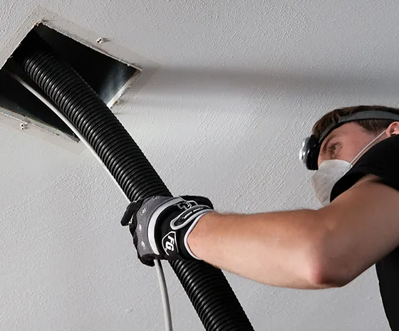 Technician performing professional air duct cleaning with vacuum equipment, improving air quality and HVAC efficiency in Oglethorpe, GA.