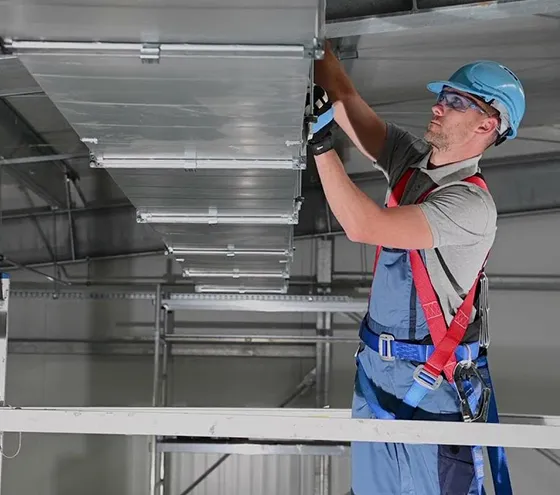 Expert technician providing professional air duct repair services in Lafayette, GA, enhancing HVAC performance and system longevity.