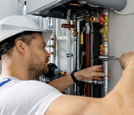 Licensed technician performing maintenance on an indoor gas fire system, ensuring reliability and safety in Lafayette, GA.